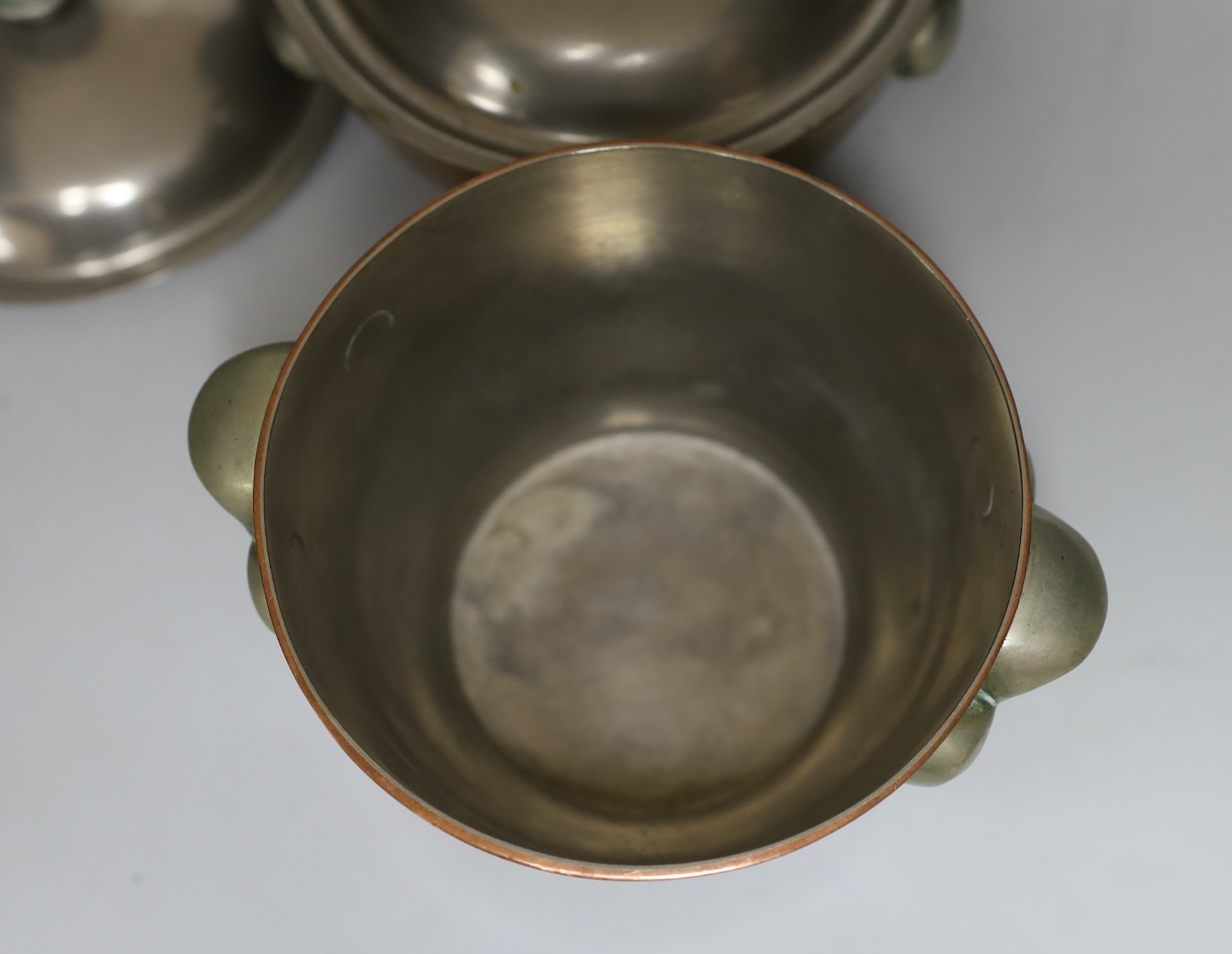 Four graduated Elkington & Co. copper bowls, three with covers, tallest 12cm